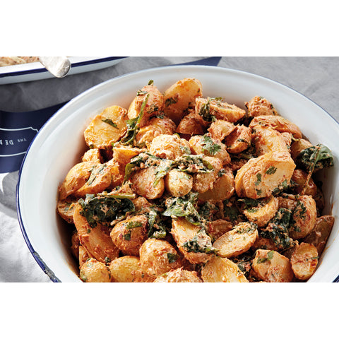 Spiced roast new potatoes, baby spinach and coriander with apricot harissa yogurt and crispy shallots